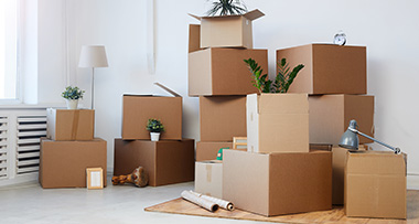 items boxed up in a room in preparation for moving out of the lease