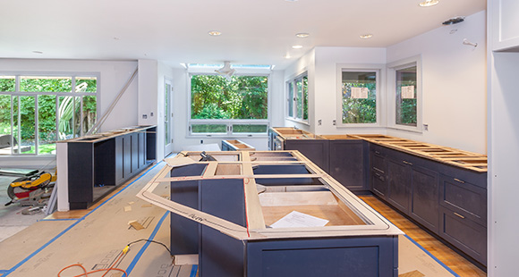 a kitchen in the midst of being renovated and installed with blue cabinets