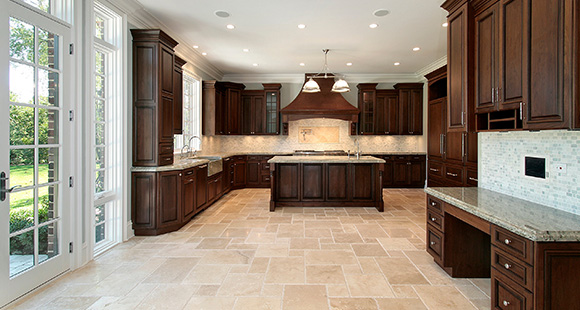 beige tile flooring in a kitchen with elegant hard wood cabinets