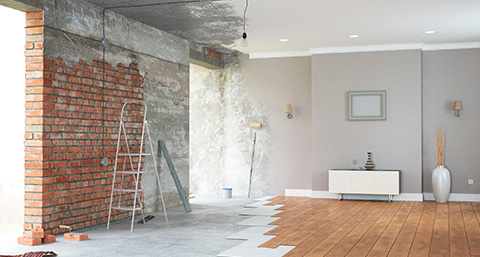 a room half renovated from brick and plater to vinyl floors and painted walls