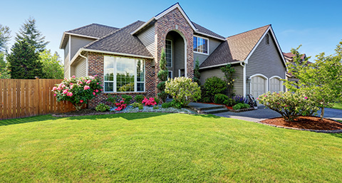 a luxury house with a large front garden